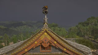 Yasuke sits perched on a tall castle spire in Assassin's Creed Shadows.